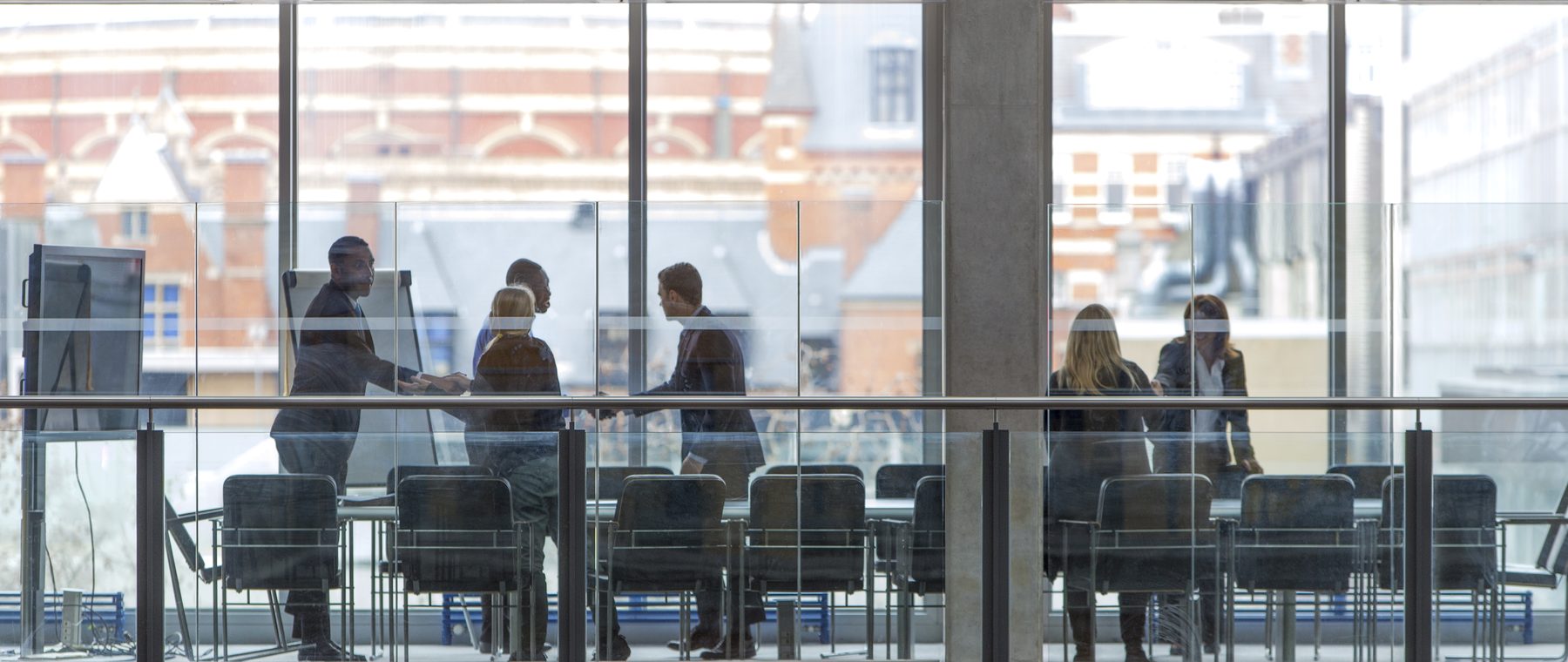 A project team meeting in a glass-walled boardroom